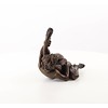 An erotic bronze sculpture of a nude female pleasing herself while lying down