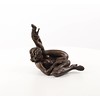 An erotic bronze sculpture of a nude female pleasing herself while lying down