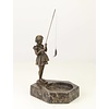 A marble ashtray with bronze sculpture of a girl fishing