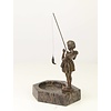 A marble ashtray with bronze sculpture of a girl fishing