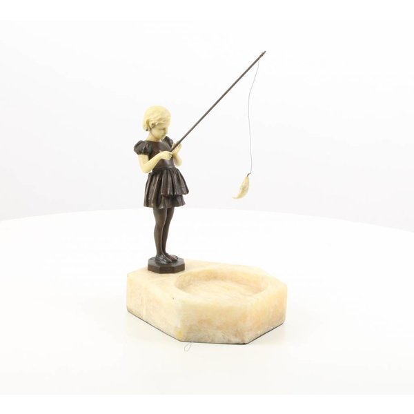  A marble ashtray of a girl holding a fishing rod