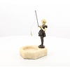 A marble ashtray of a girl holding a fishing rod