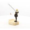 A marble ashtray of a girl holding a fishing rod