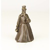 A bronze figural table bell of a gentleman