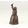 A bronze figural table bell of a drinking monk