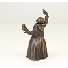 A bronze figural table bell of a drinking monk