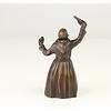 A bronze figural table bell of a drinking monk
