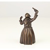 A bronze figural table bell of a drinking monk