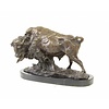 A bronze sculpture of a standing buffalo