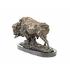 A bronze sculpture of a standing buffalo