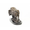 A bronze sculpture of a standing buffalo