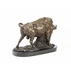 A bronze sculpture of a standing buffalo