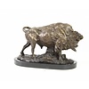 A bronze sculpture of a standing buffalo