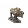 A bronze sculpture of a standing buffalo