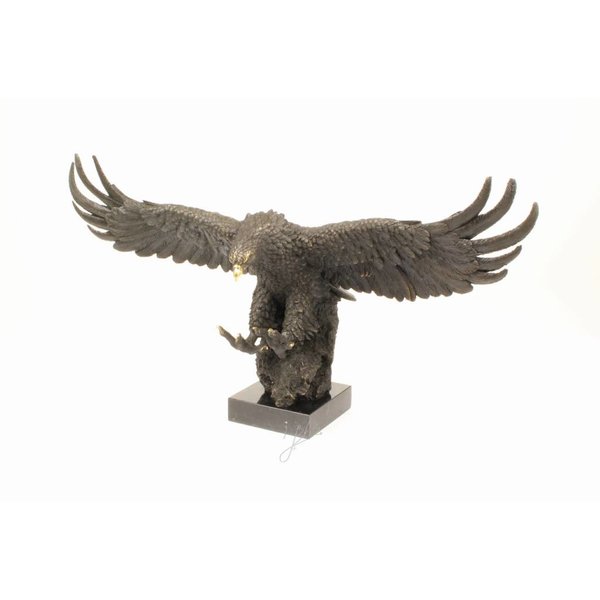  A large bronze sculpture of a descending eagle