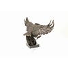 A large bronze sculpture of a descending eagle