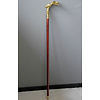 A wooden walking stick with bronze grip of intense female nude