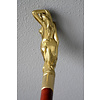 A wooden walking stick with bronze grip of intense female nude