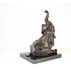 A  bronze sculpture of a sitting elephant