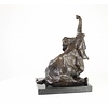 A  bronze sculpture of a sitting elephant