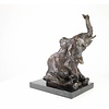 A  bronze sculpture of a sitting elephant