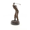 A bronze sculpture of a male golfer