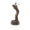 A bronze sculpture of a male golfer