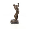 A bronze sculpture of a male golfer