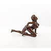 A bronze sculpture of a female nude crawling