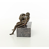A bronze sculpture of a blowjob scene