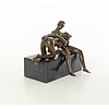 A bronze sculpture of a blowjob scene