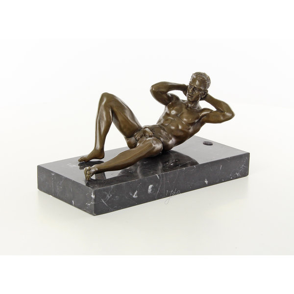  A bronze sculpture of a reclining male nude