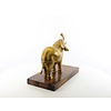 A bronze sculpture of an elephant on a wooden base