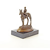 A bronze sculpture of a racehorse and jockey