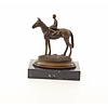 A bronze sculpture of a racehorse and jockey