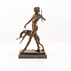 A bronze sculpture of the goddess Diana with hound