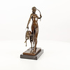 A bronze sculpture of the goddess Diana with hound