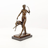 A bronze sculpture of the goddess Diana with hound