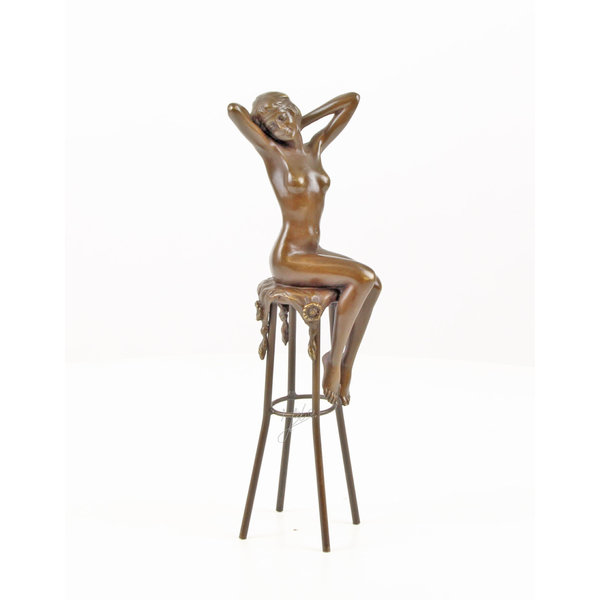  A bronze sculpture of a female nude seated on a barstool