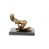 A bronze sculpture of a kneeling female nude