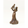 A bronze table bell of a female holding child