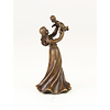 Een bronzen tafelbel van een vrouw dat kind vasthoudt