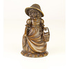 A bronze figural table bell of a young girl