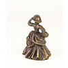 A bronze table bell of a lady with basket