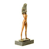 A bronze sculpture of an undressing female