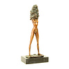 A bronze sculpture of an undressing female