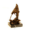 A bronze sculpture of a cardinal bird