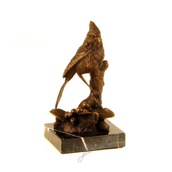  A bronze sculpture of a cardinal bird