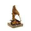 A bronze sculpture of a cardinal bird