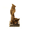 A bronze sculpture of a cardinal bird